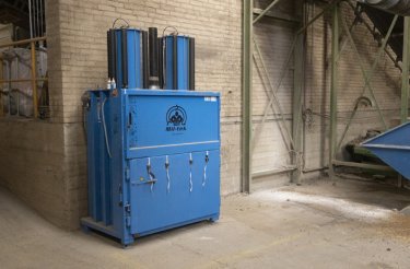 blue baler 2509 standing against brick wall