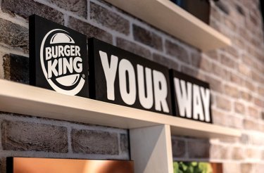 Shelf mounted on a brick wall featuring a sign with Burger King logo and the slogan 'Your Way'