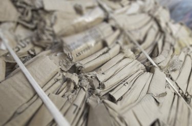 close up of cardboard bale with white strapping