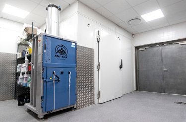 Rented blue baler in a cleared back room