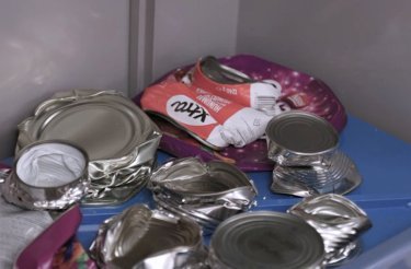 Flattened aluminum cans compressed by a commercial can crusher