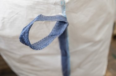 close up of white big bag with blue band