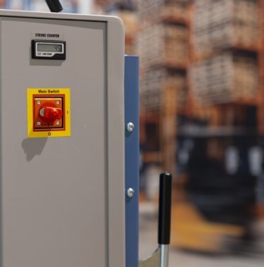 red button on side of baler