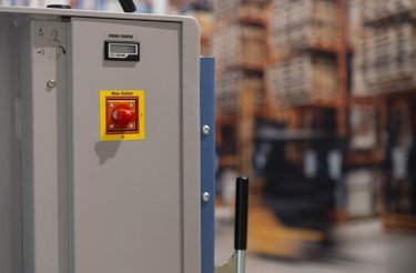 red button on side of baler