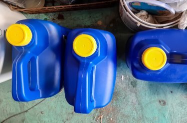three blue plastic bottles with yellow lids