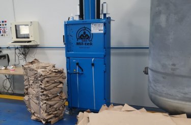 blue baler next to a small bale at real pet food company