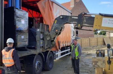 baler arriving with truck to truelove properties