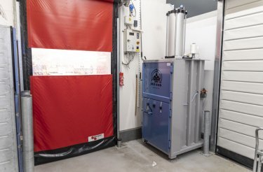 vertical baler installed near backdoor with red color